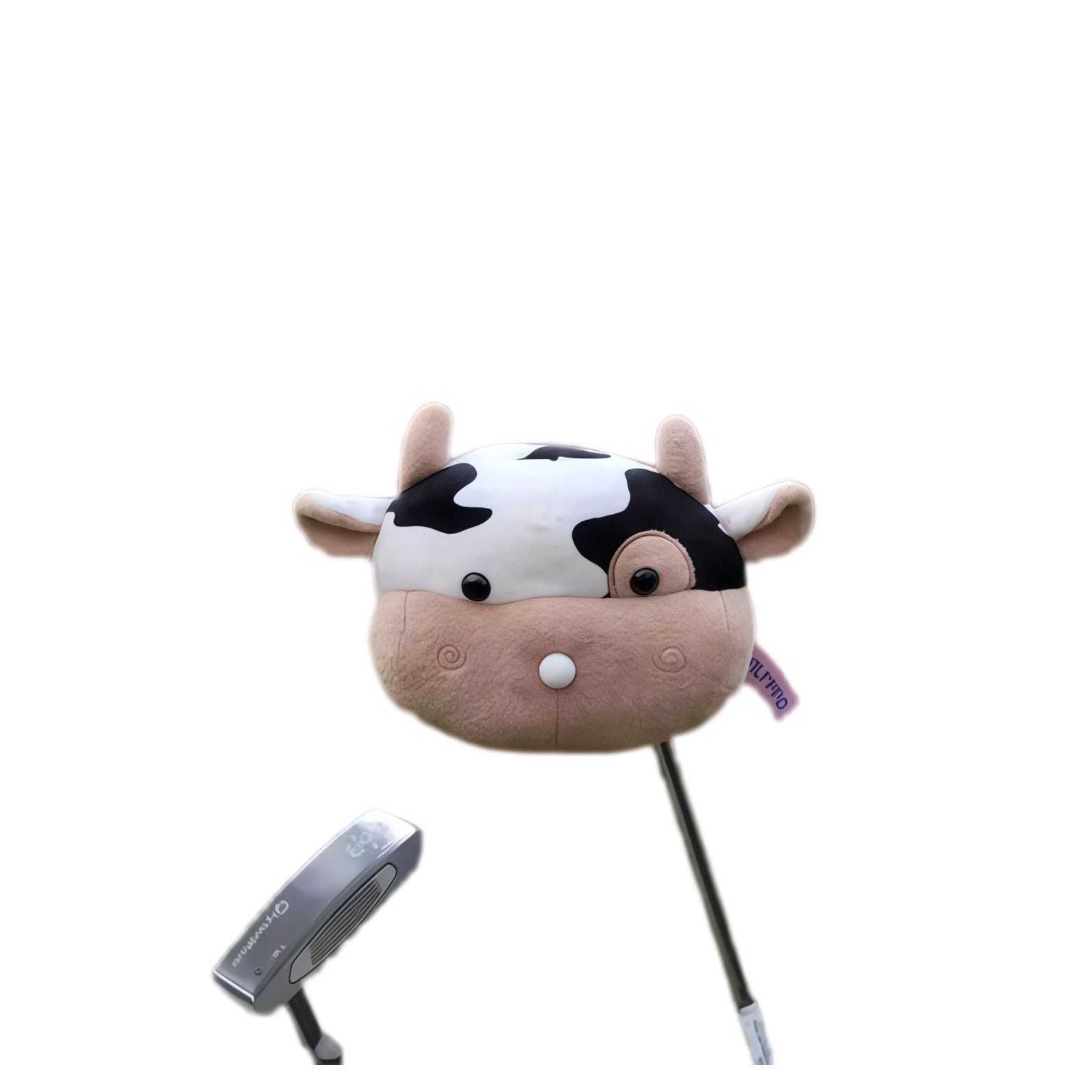 Top-down angle of cow plush golf headcover showing horns, ear flaps and white tee detail at the muzzle