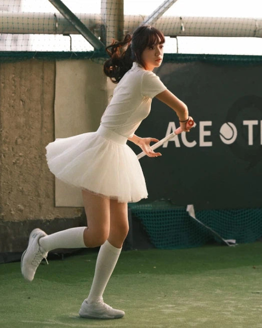 NowRose White polo and skirt in golf action