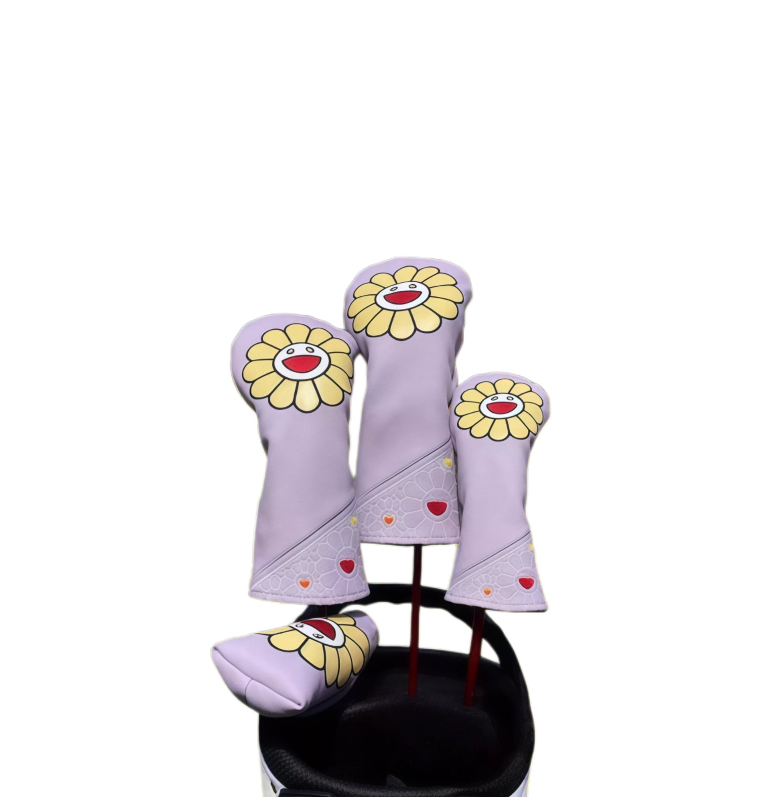 Lilac purple sunflower-face golf headcover set with driver, fairway, hybrid and blade putter covers on a cart bag