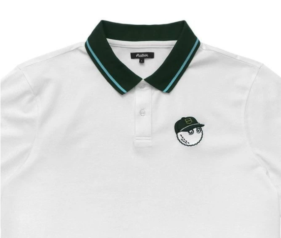 White polo shirt with green collar and logo on a white background#White