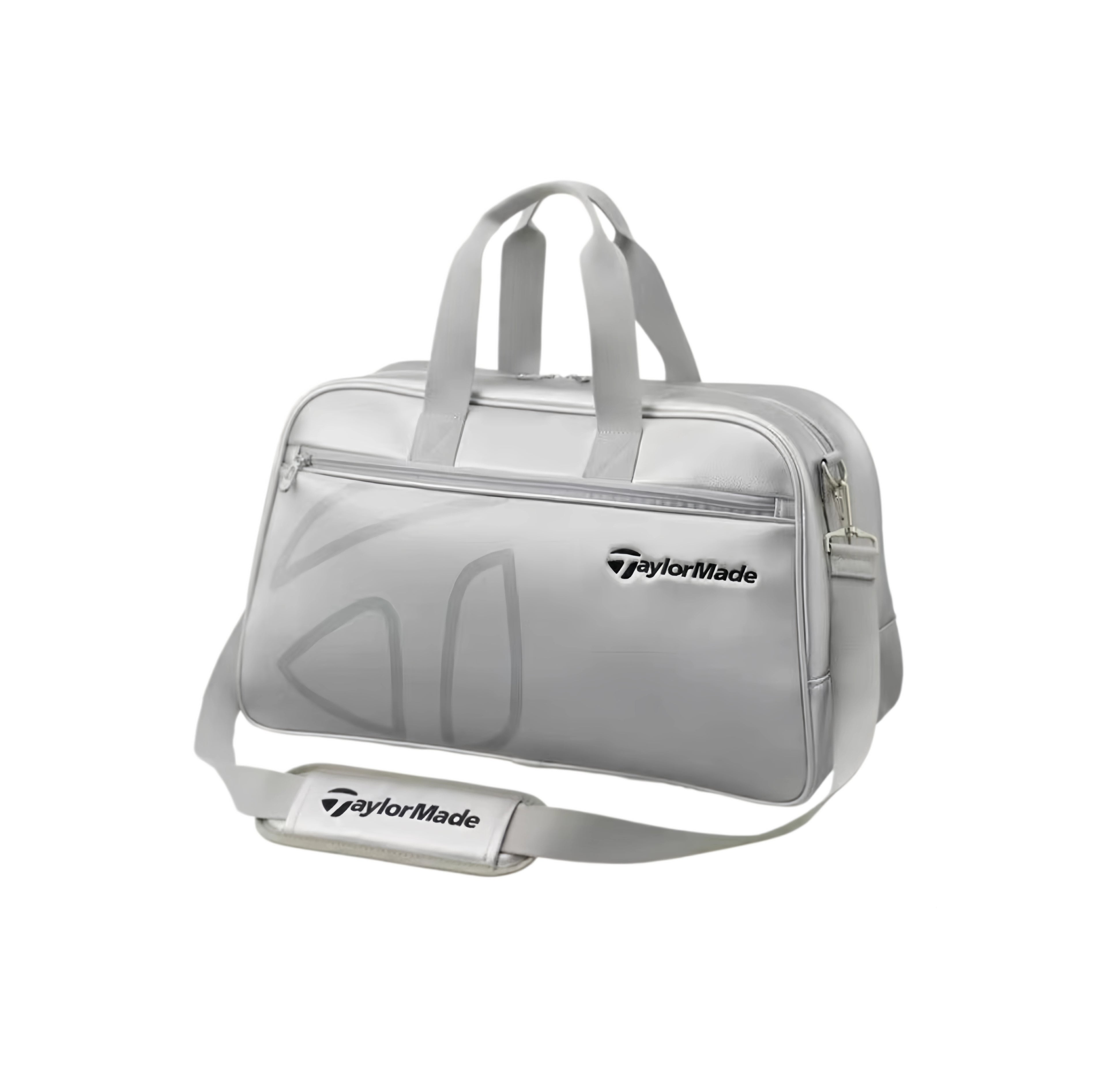 Light grey TaylorMade Auth-Tech Boston bag with front zip pocket, branded shoulder strap pad and tonal embossed logo, angled view