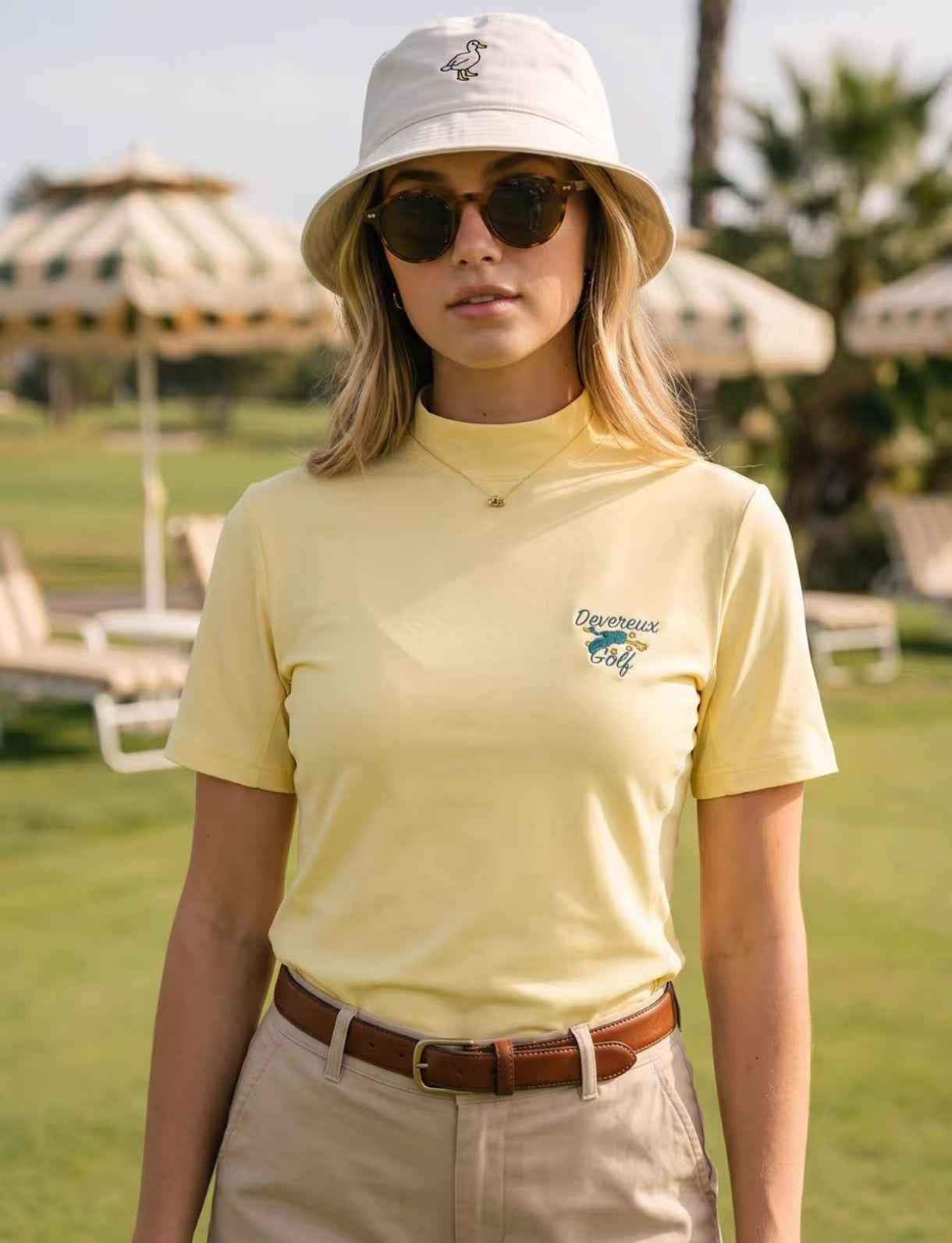 Devereux Yellow printed mock-neck golf tee front view on model