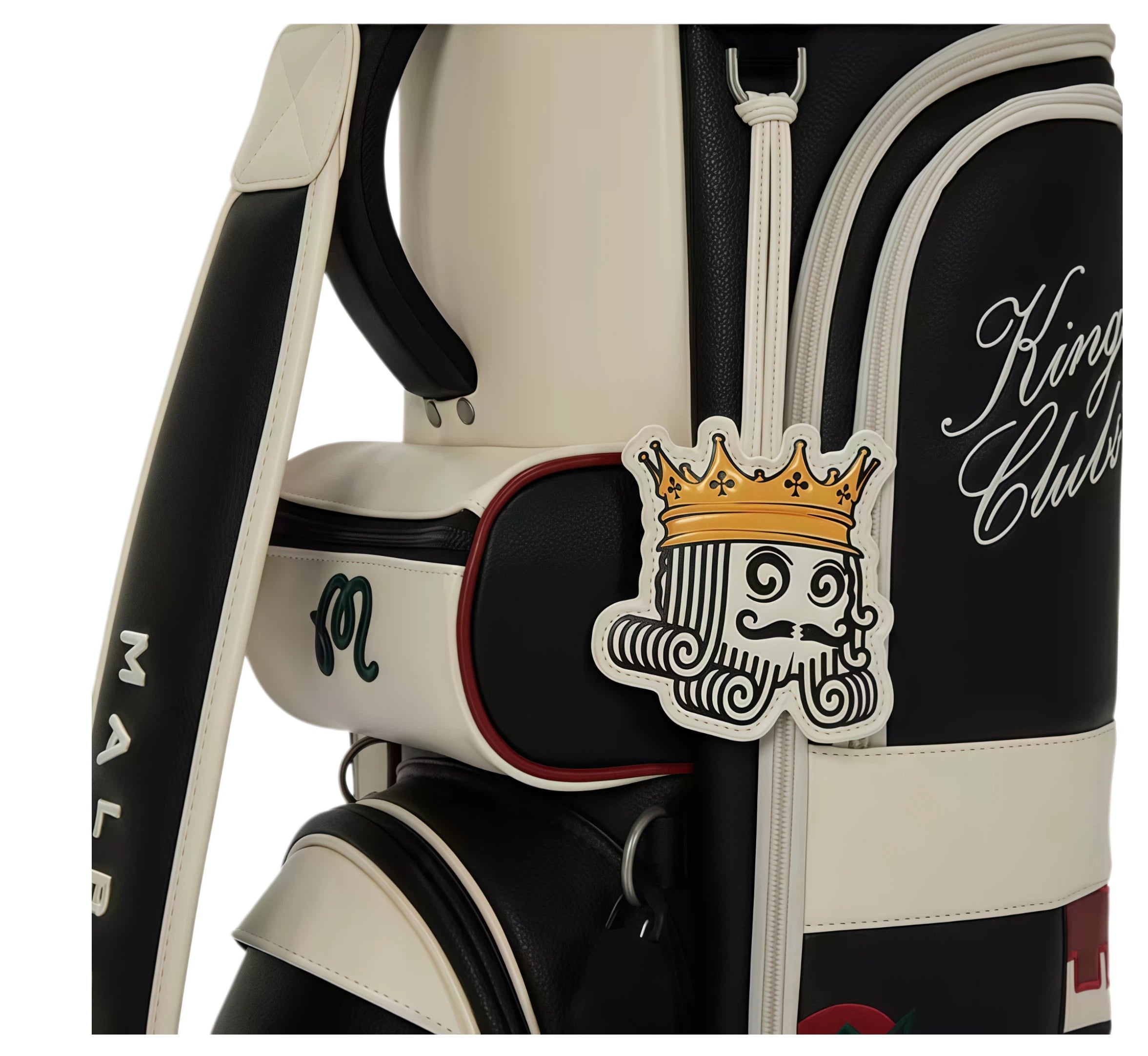 Detailed close-up of Malbon Golf bag’s iconic king mascot patch with gold crown, attached to zipper pull; adjacent to 'King of Clubs' embroidery and textured black/cream panels.