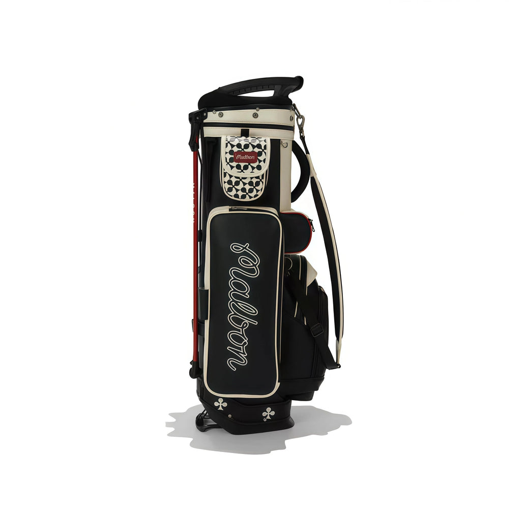 Full frontal view of Malbon Golf King of Clubs Stand Bag on white background, highlighting clover-shaped base feet, premium faux leather texture, and signature crown emblem.