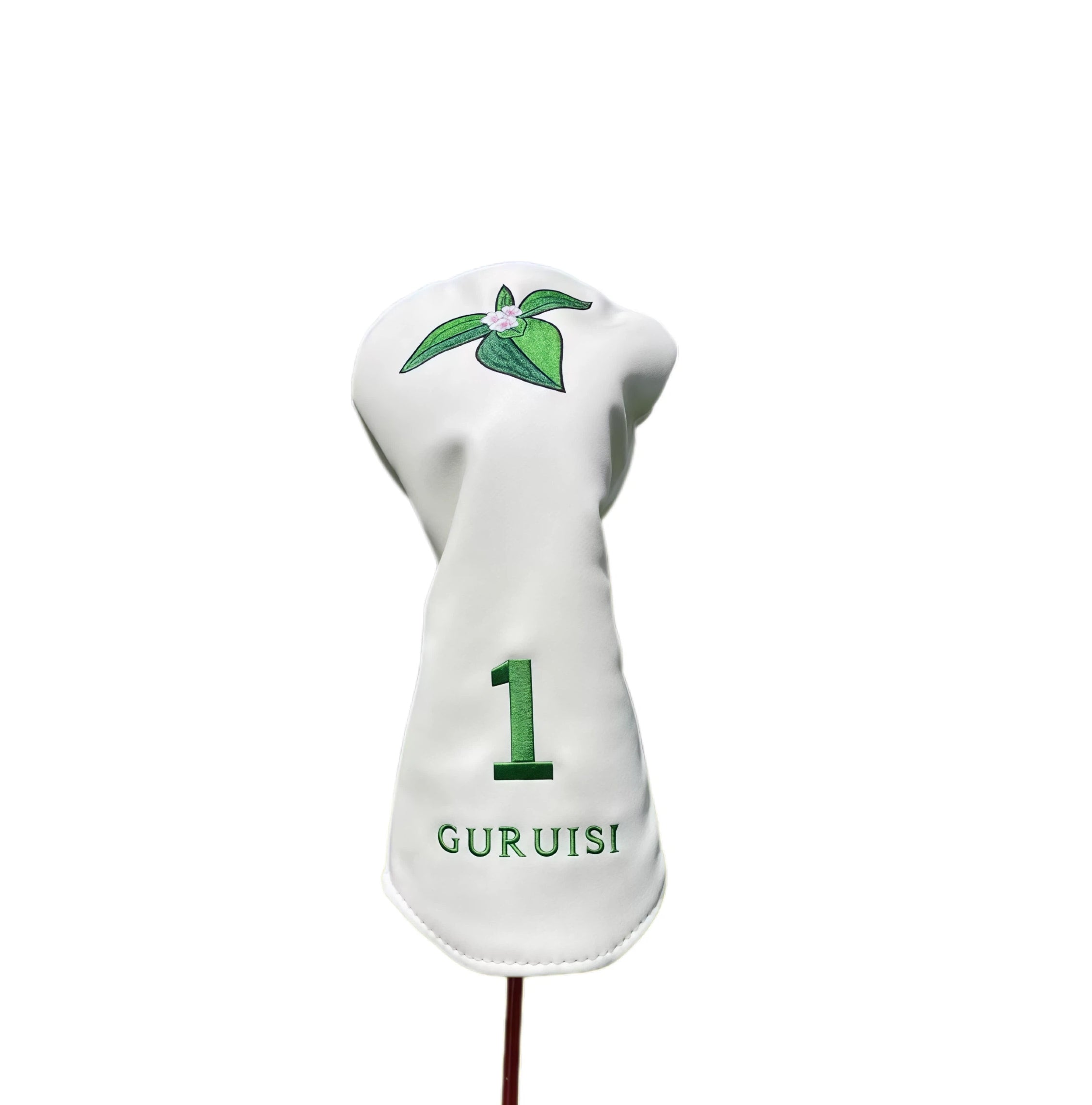 Close-up of GURUISI white driver headcover with embroidered leaf and flower pattern — features large number "1" and brand name "GURUISI" in green thread for easy identification and elegant look.