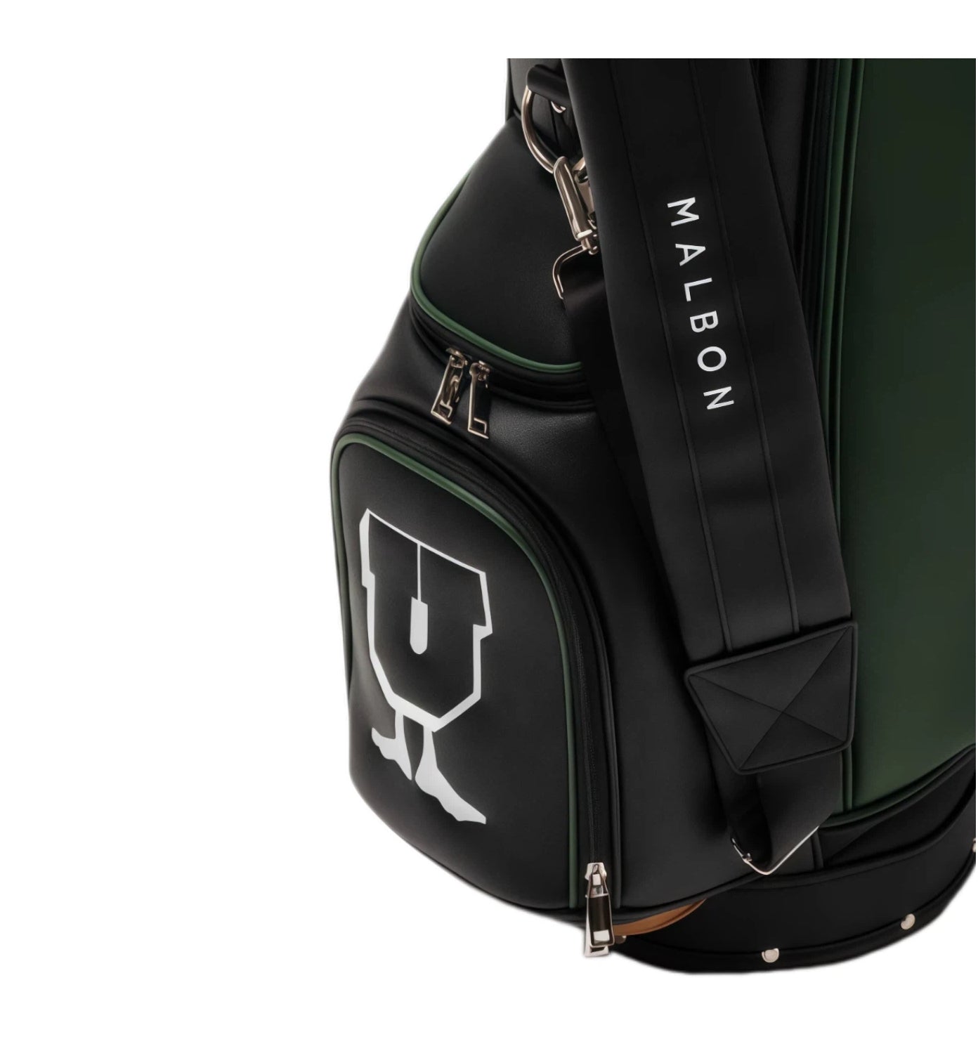 Detail shot of Malbon Golf bag’s lower storage pocket with white trophy-style graphic, green piping, and padded shoulder strap with vertical 'MALBON' lettering in white.