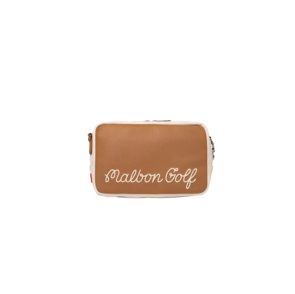 Backside of the tan Malbon performance crossbody bag displaying elegant white "Malbon Golf" cursive embroidery. Minimalist and brand-focused design