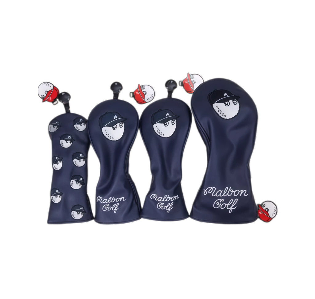 Navy blue Malbon golf headcover covered in repeating cartoon baseball captain faces, shown with red-and-white magnetic ball clip attached to top loop.
