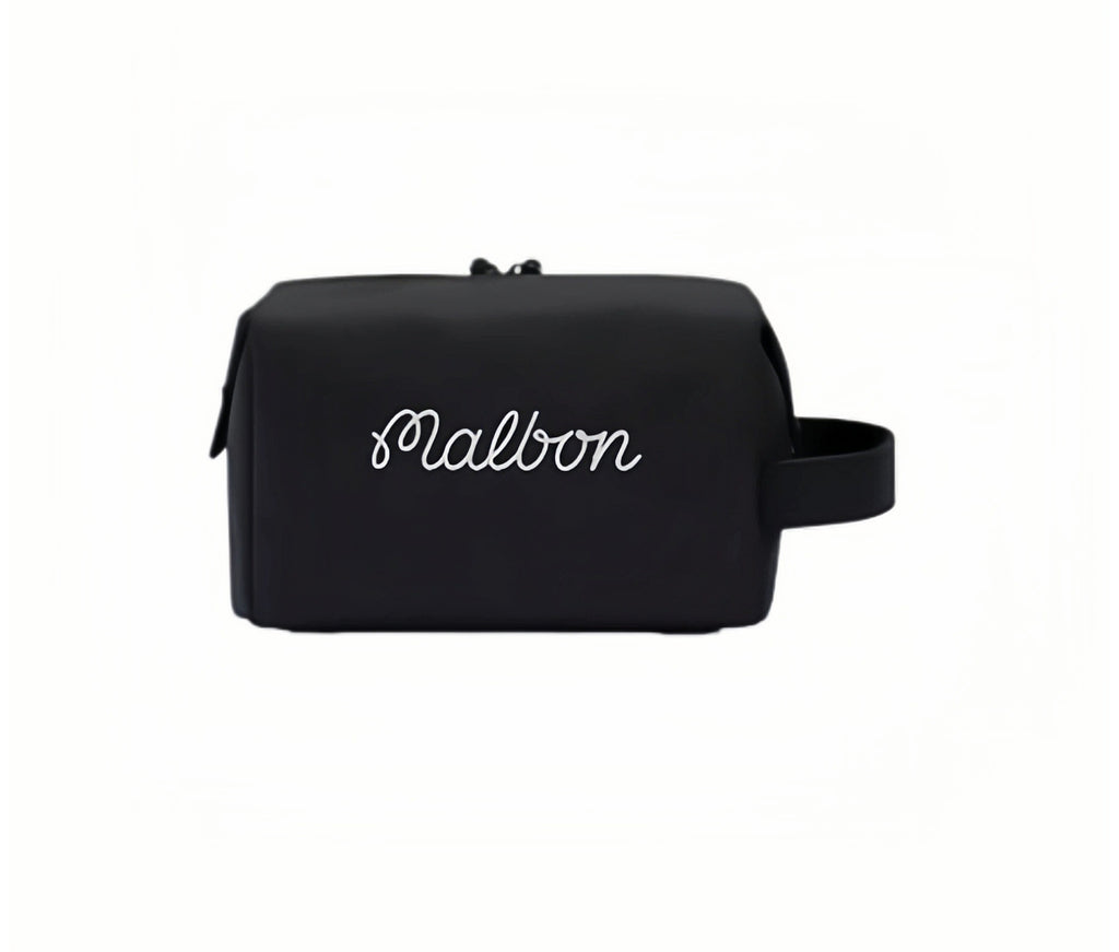 Back view of black Malbon Golf mini handbag displaying elegant white cursive "Malbon" branding, minimalist design, and functional wrist handle