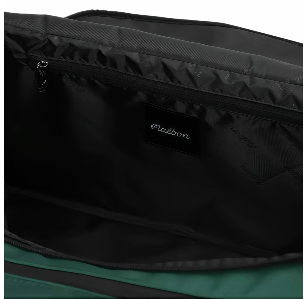 Close-up of the interior of Malbon Golf Performance duffel bag showing black lining with subtle "Malbon" pattern print and embroidered brand label