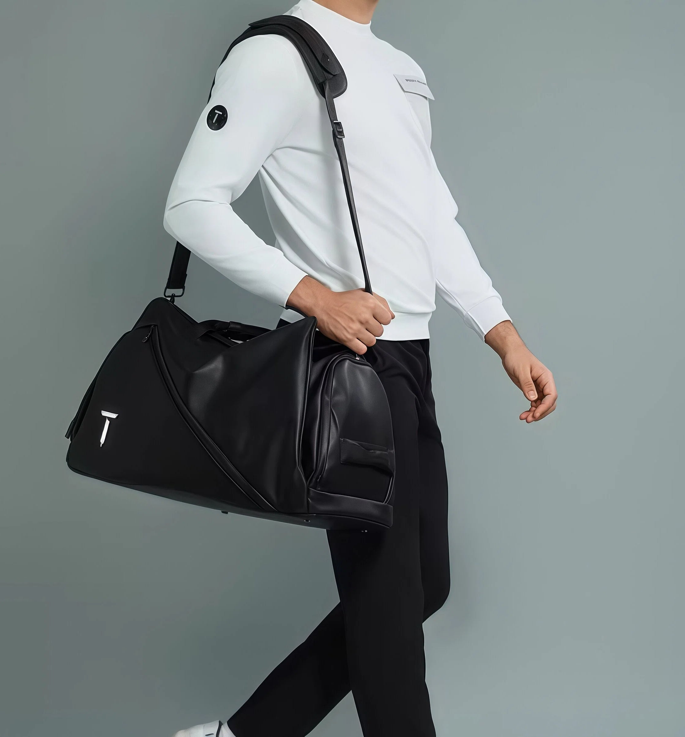 Man wearing the black European Tour duffel bag over his shoulder, showcasing its sleek design and practicality. Perfect for golf, gym, or daily use.