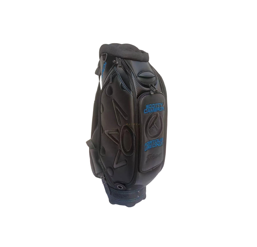 Close-up of the ball pocket on the Scotty Cameron Backin Black Staff Bag, featuring "SCOTTY CAMERON" and "FOR TOUR USE ONLY" embroidery in blue with the Titleist logo below.