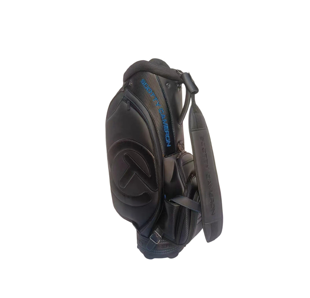  Full side profile of the Scotty Cameron Backin Black Tour Staff Bag showcasing the Circle T headcover logo, extensive pocketing, and "FOR TOUR USE ONLY" text on the base.