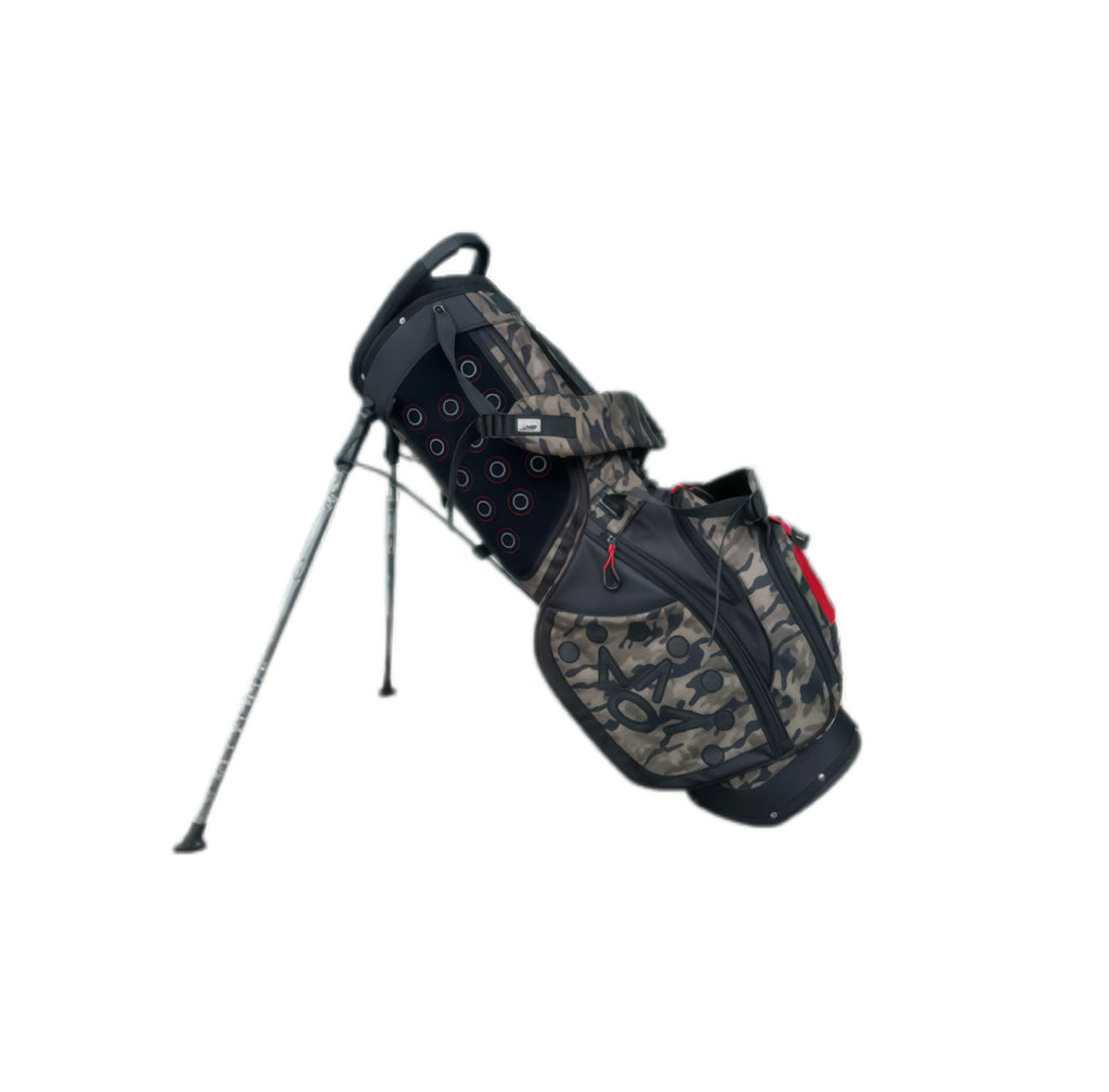 Back view of the Scotty Cameron Junior Camo-Red Stand Bag, showcasing the dual-strap system, stand legs, and camouflage pattern with black trim and red zipper pulls.