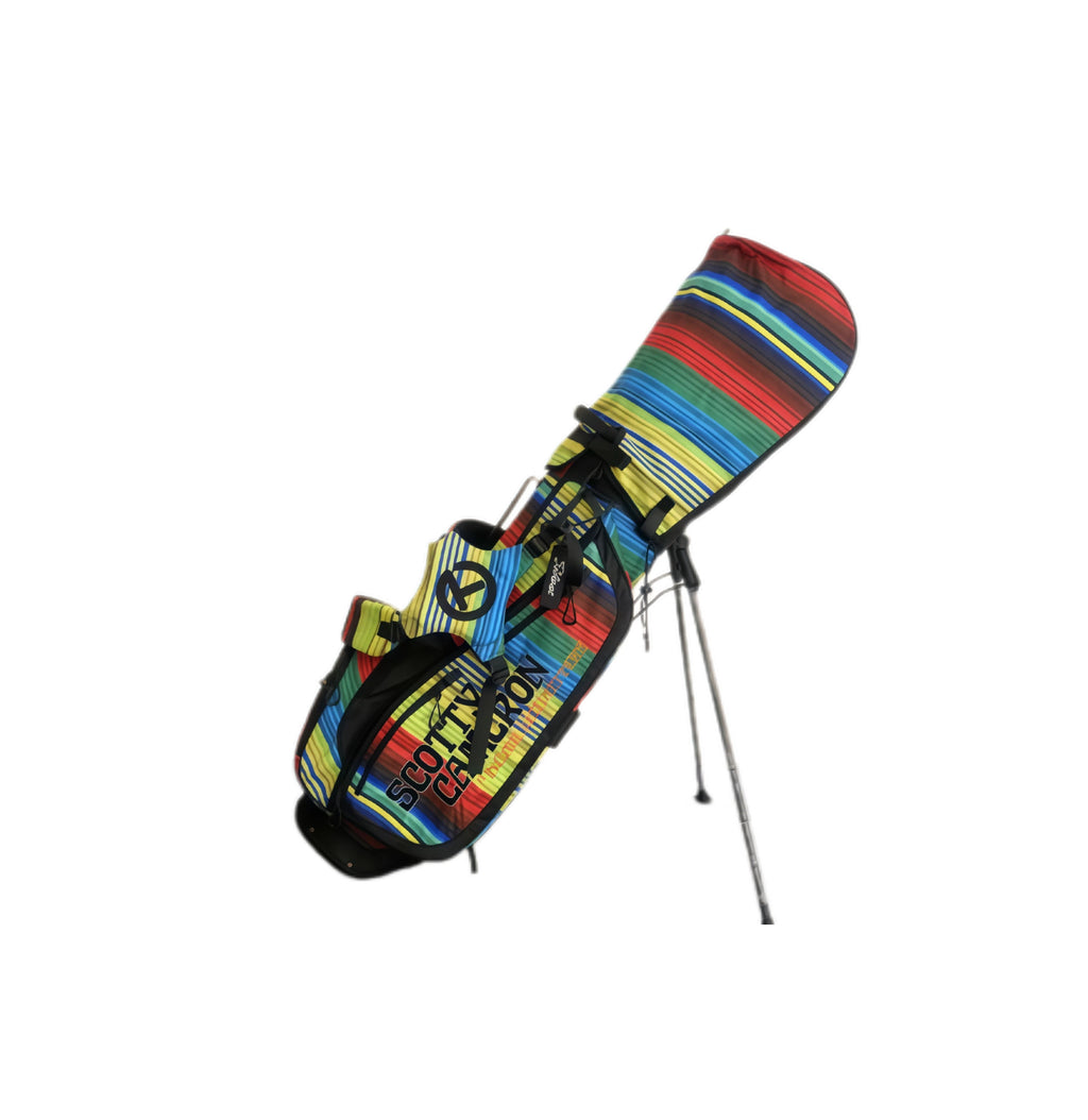 A side profile of the Scotty Cameron Junior Serape Stand Bag with the matching striped headcover attached. The image highlights the "SCOTTY CAMERON" branding and the durable dual-strap system designed for easy carrying.
