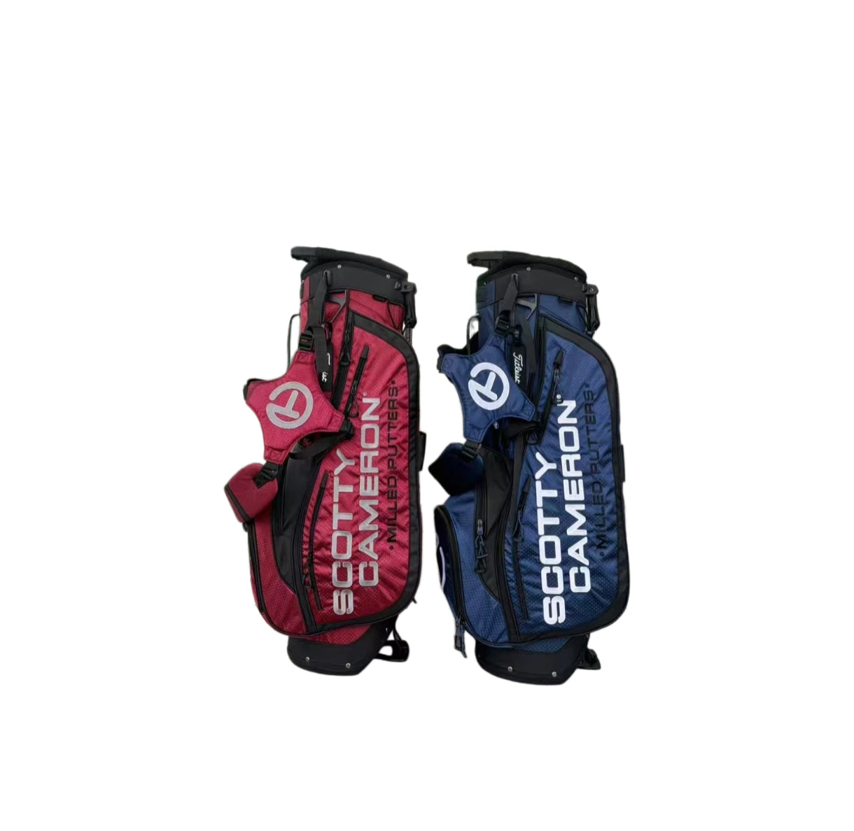  Front view of the Scotty Cameron Pathfinder Mainstay Stand Bags in red and blue. The image highlights the large "SCOTTY CAMERON" typography and the zippered front pockets with Circle T branding.