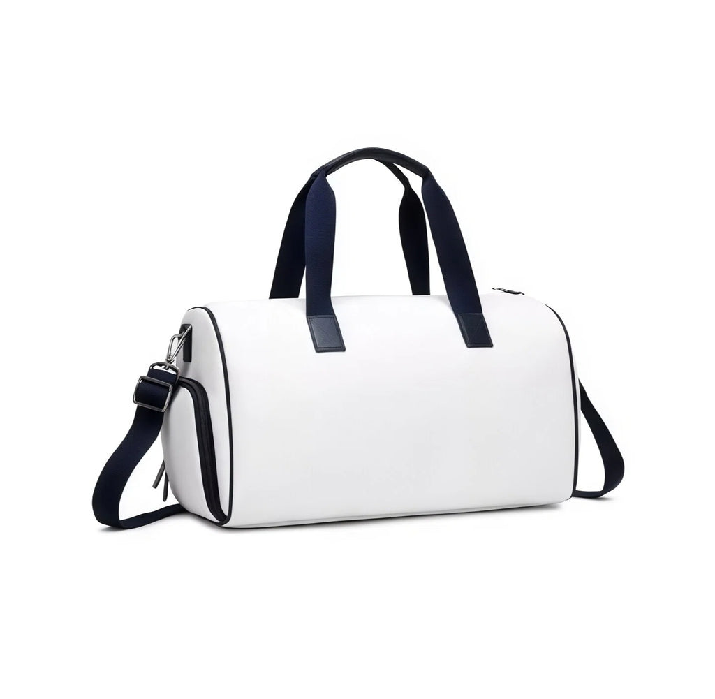Side angle view of the white PGA Tour duffel bag highlighting its sleek silhouette, navy trim, and durable construction. Features a zippered side pocket and padded handle grip.
