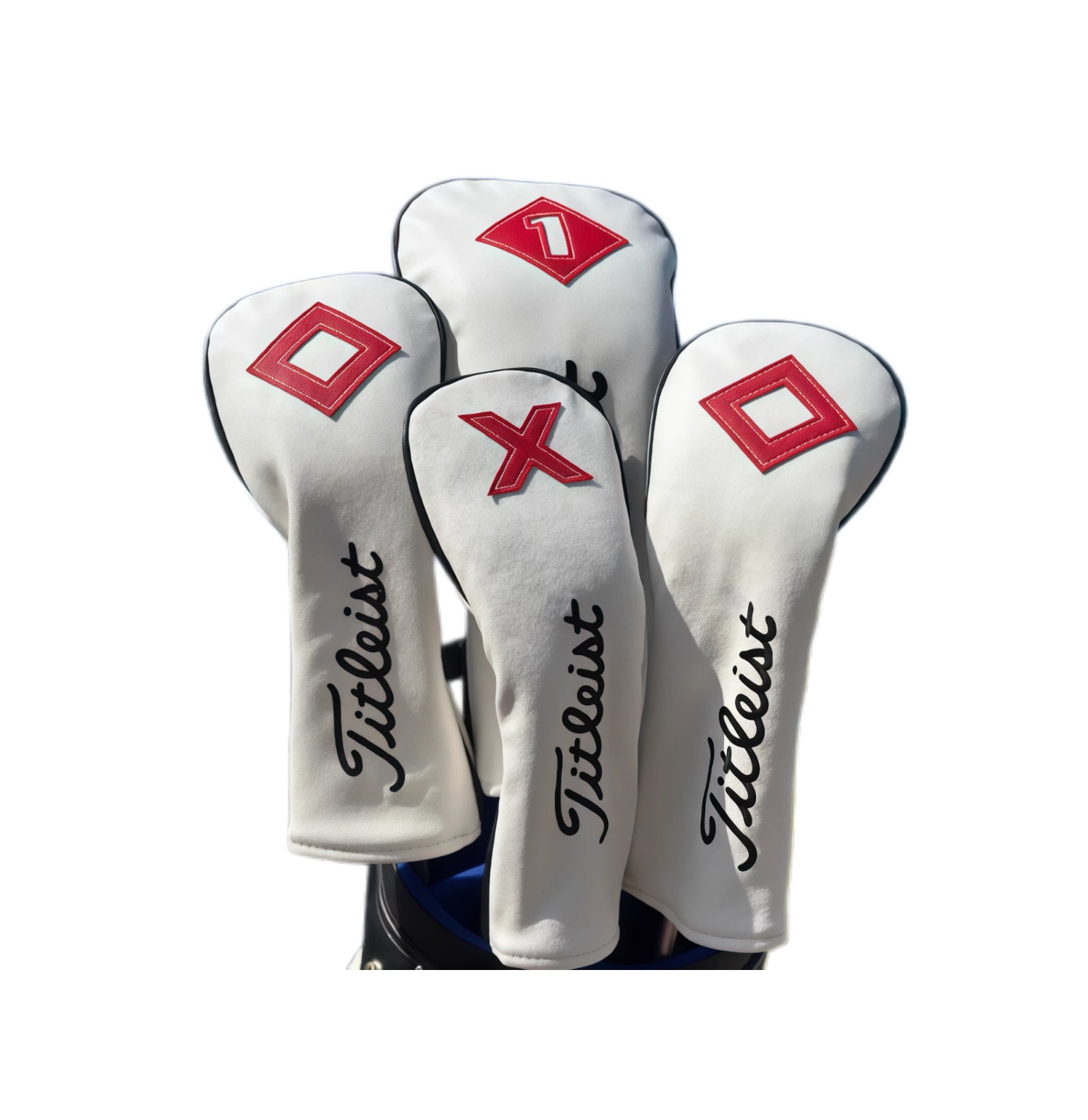 Set of four white Titleist-style golf headcovers in a golf bag, including one marked "1", one with an "X", and two with red diamond symbols — each featuring the iconic black "Titleist" script and high-quality stitching for durable club protection.
