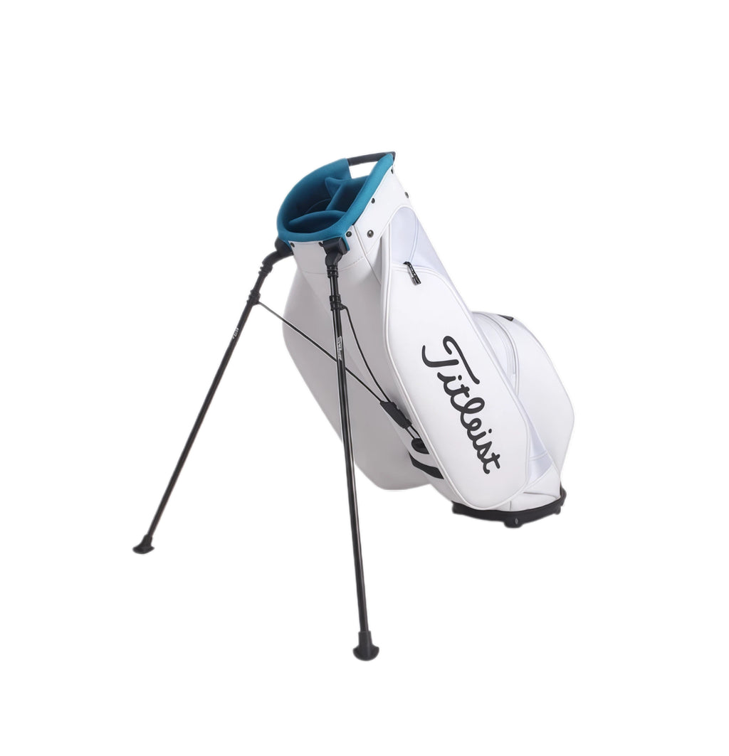 Back view of the Titleist TB23ASBA stand golf bag showing fully extended dual stand legs for stable placement on grass or turf. Features a padded base and reinforced stitching for durability during play.