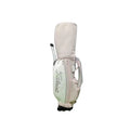 Side profile of the Titleist Waterproof Stand Golf Bag showcasing its telescoping handle, lightweight design, and pastel pink and mint color blocking with the Titleist branding.
